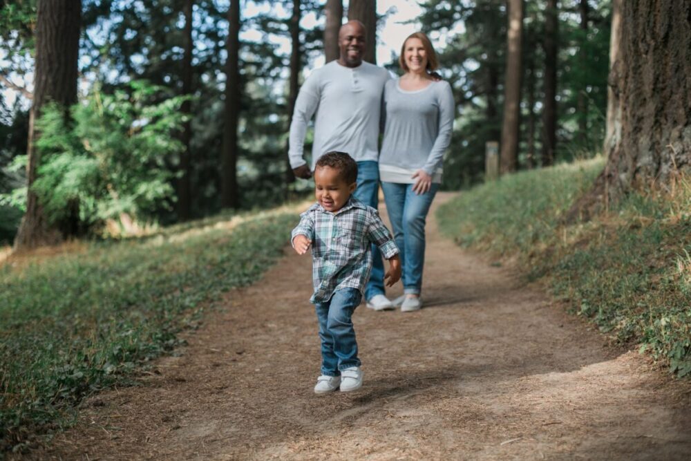 Family exploring forested path together